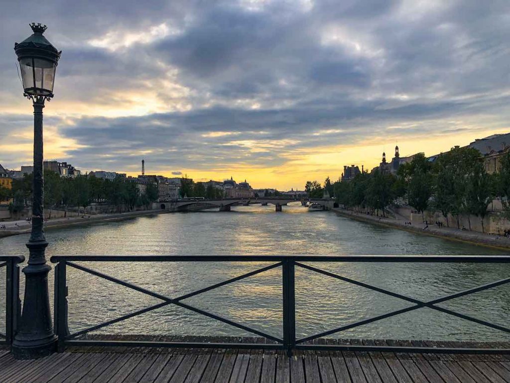 The locks of love bridge Paris offers a gorgeous view over the Seine River and the Eiffel tower